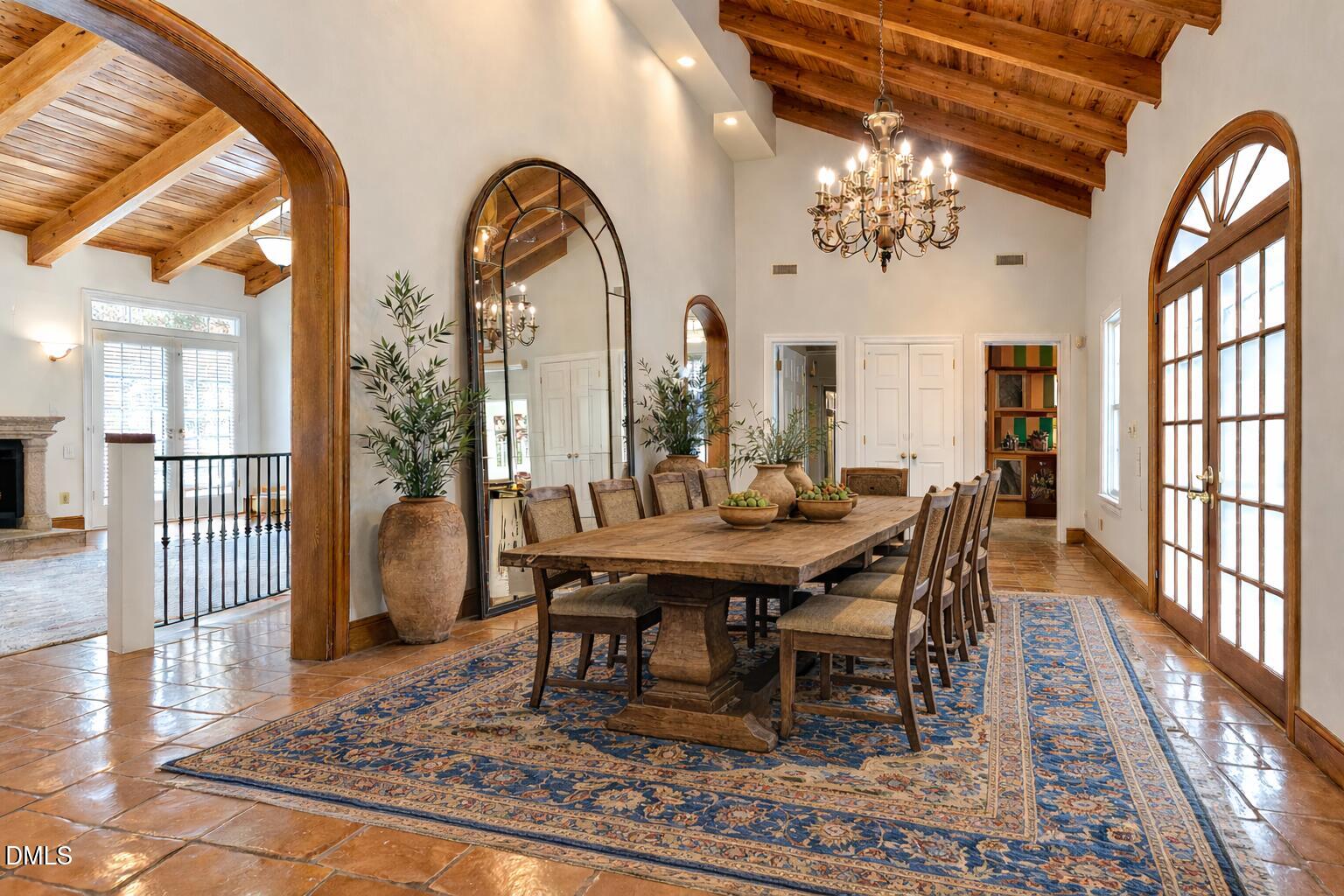 a view of a dining room with furniture a chandelier and wooden floor