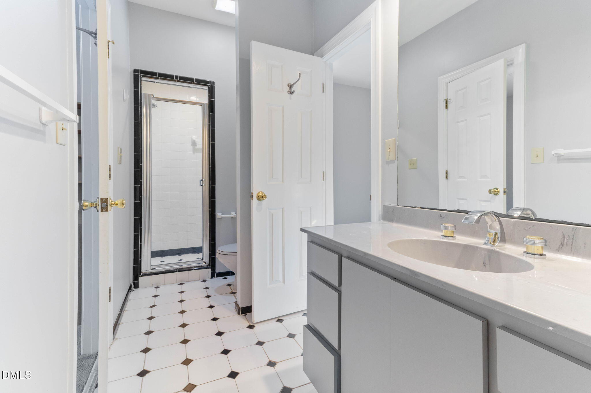 4205 Swarthmore Road Durham, NC 27707 - Photo 12 of 86 a bathroom with a sink a mirror a shower and a toilet