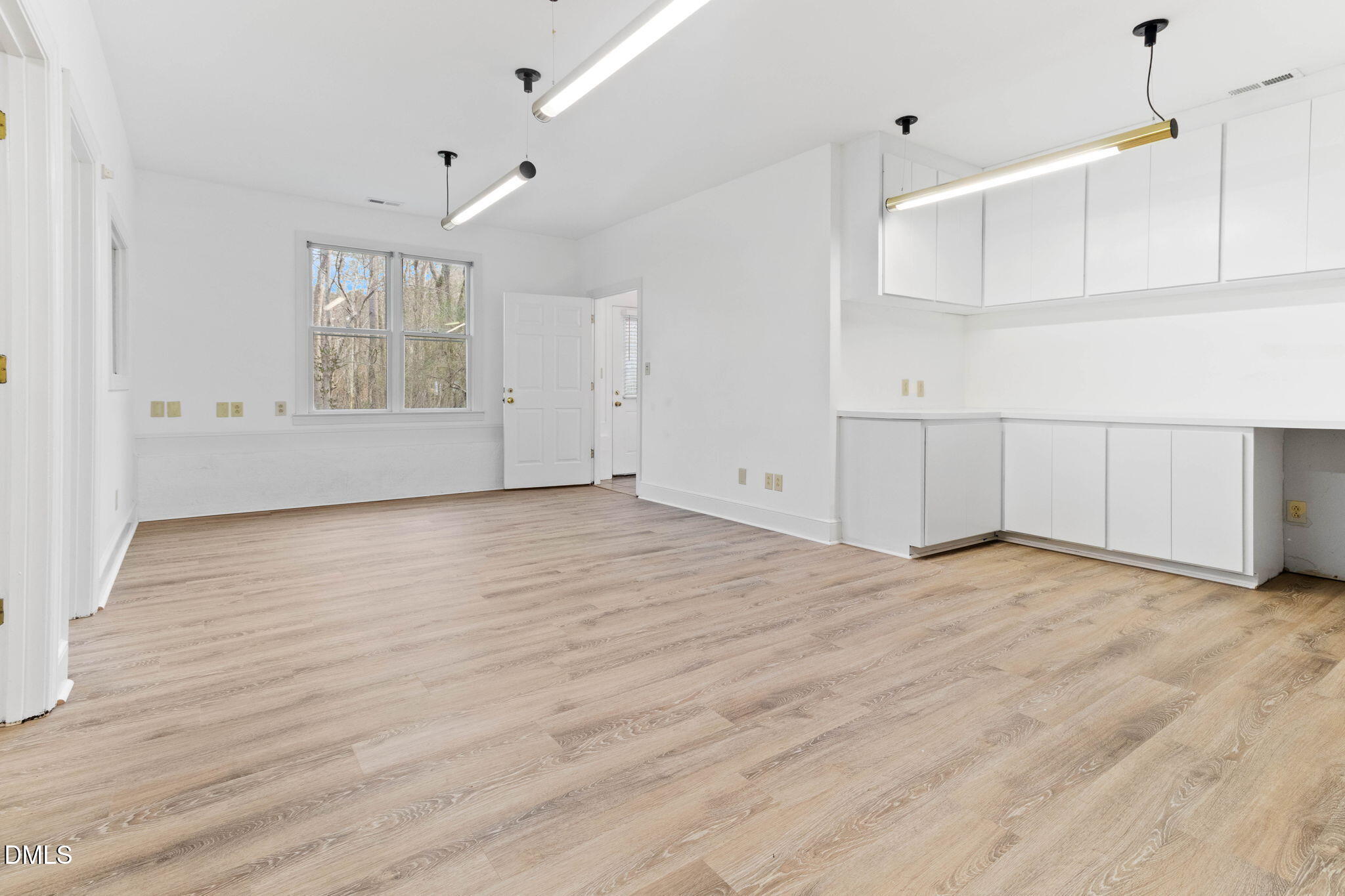 4205 Swarthmore Road Durham, NC 27707 - Photo 65 of 86 a view of an empty room with wooden floor and windows