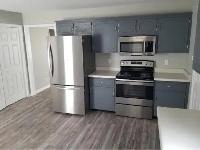 a kitchen with a refrigerator stove and microwave
