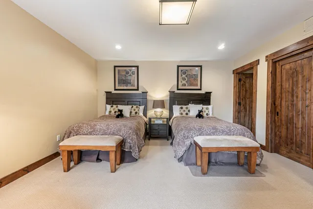 a bedroom with two beds and a window