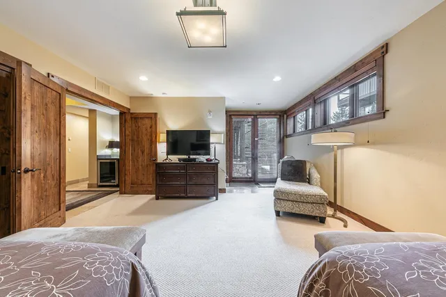 a bedroom with furniture and a flat screen tv