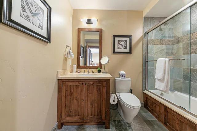 a bathroom with a toilet a sink and shower