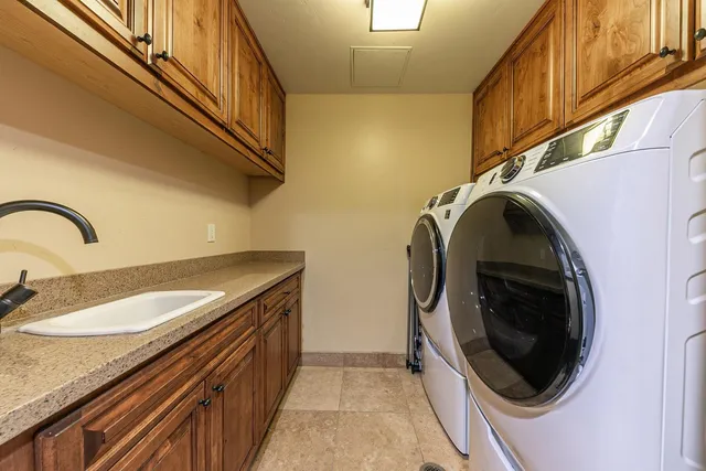 a utility room with sink dryer and washer