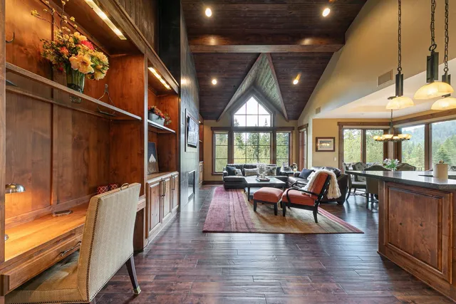 a living room with furniture a window and wooden floor