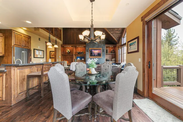 a view of a dining room with furniture wooden floor and chandelier