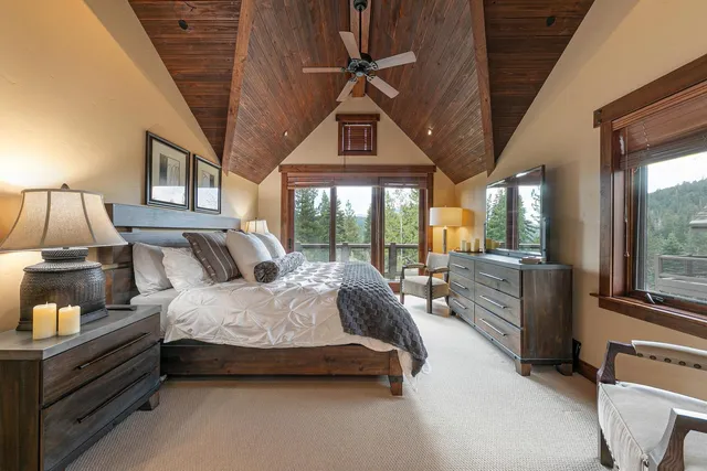 a spacious bedroom with a bed couch and a large window