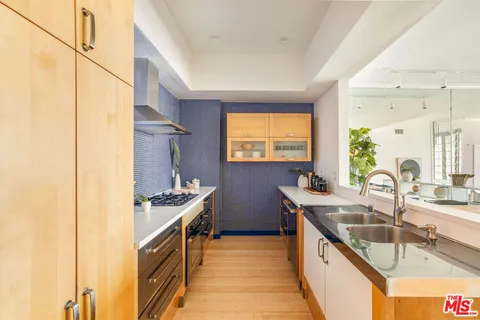 a kitchen with stainless steel appliances a sink stove and cabinets