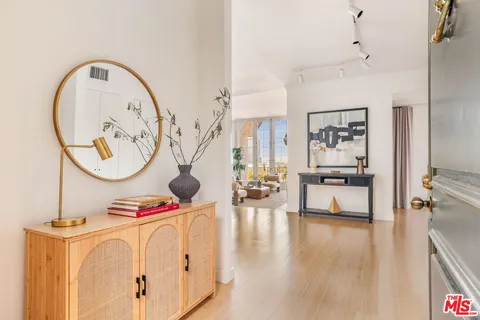 a living room with lots of furniture and a large window