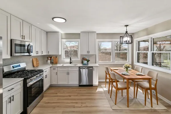 a kitchen with a stove a sink and a refrigerator