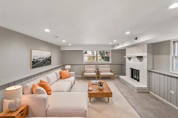 a living room with furniture and a fireplace