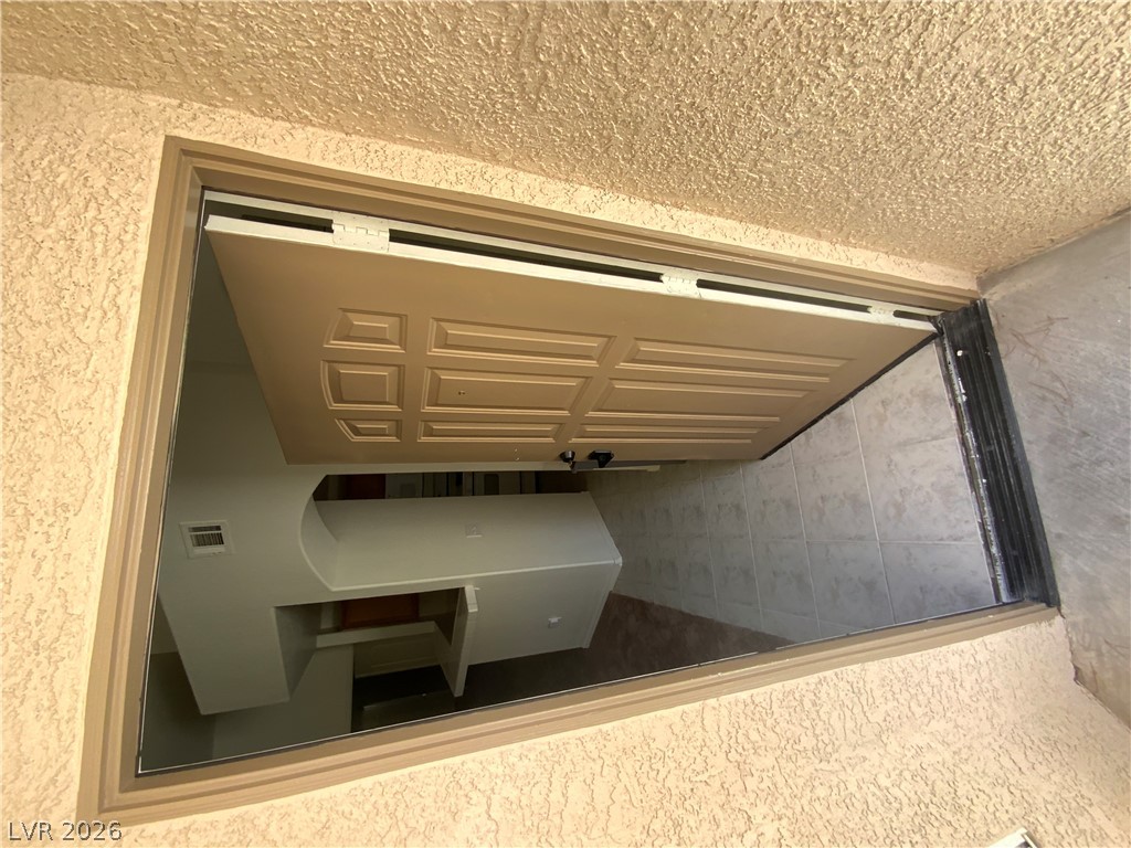 7400 West Flamingo Road, Unit 1039 Las Vegas, NV 89147 - Photo 3 of 40 Secure entry opens to a tiled foyer, hinting at the spacious interiors beyond.