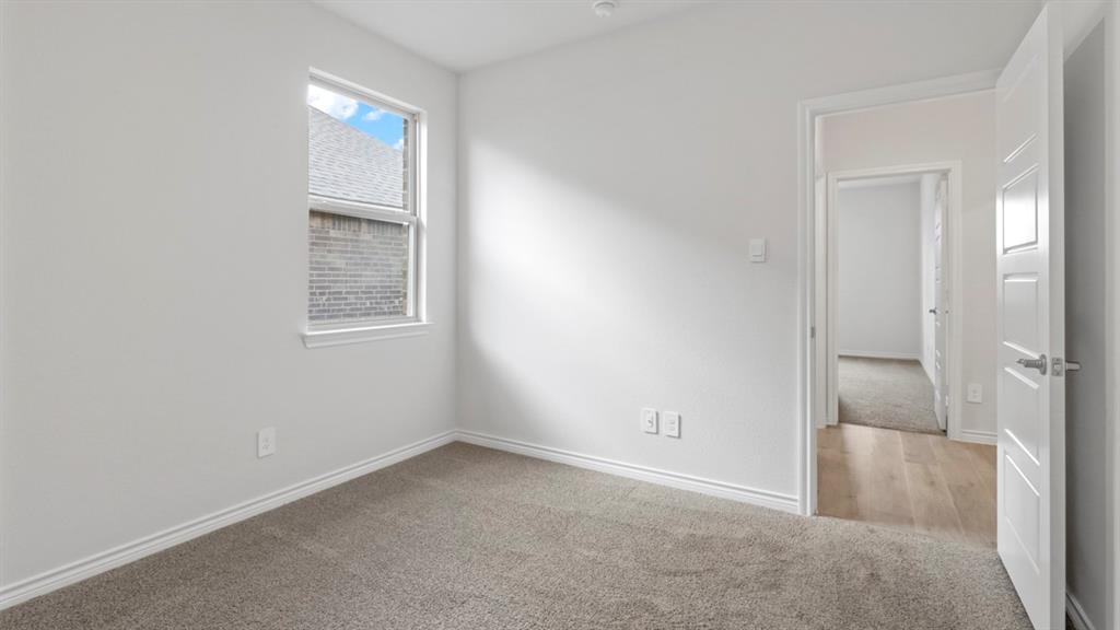 510 Range Road Caddo Mills, TX 75135 - Photo 4 of 25 Spare room featuring light colored carpet and baseboards