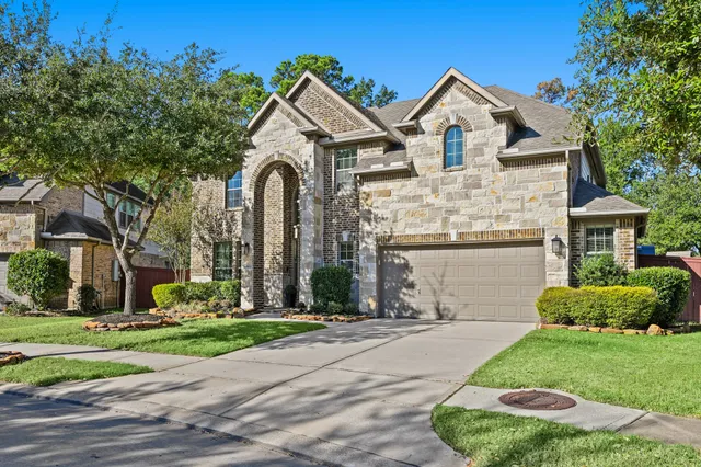 a front view of a house with a garden and plants