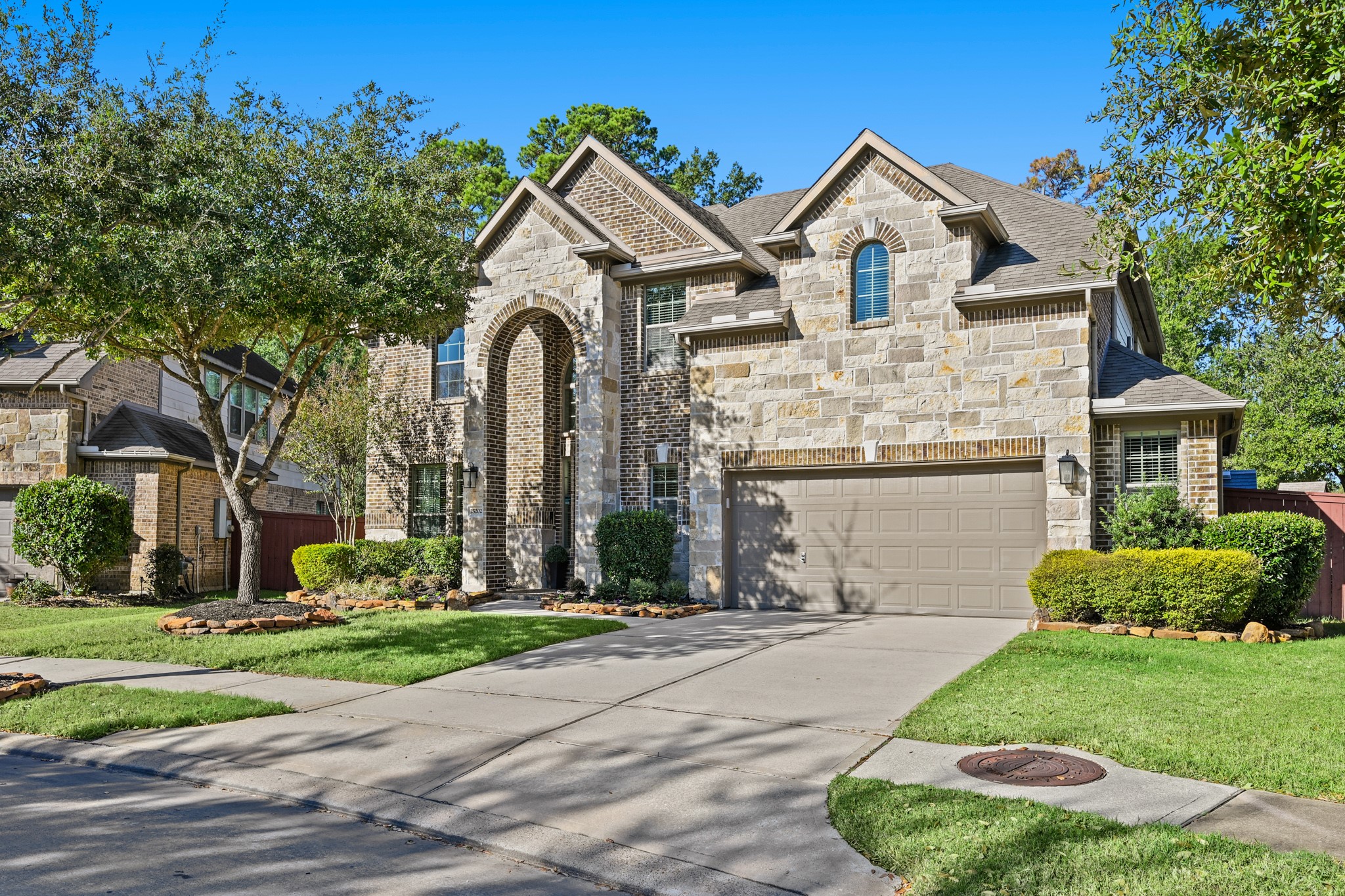 a front view of a house with a garden and plants
