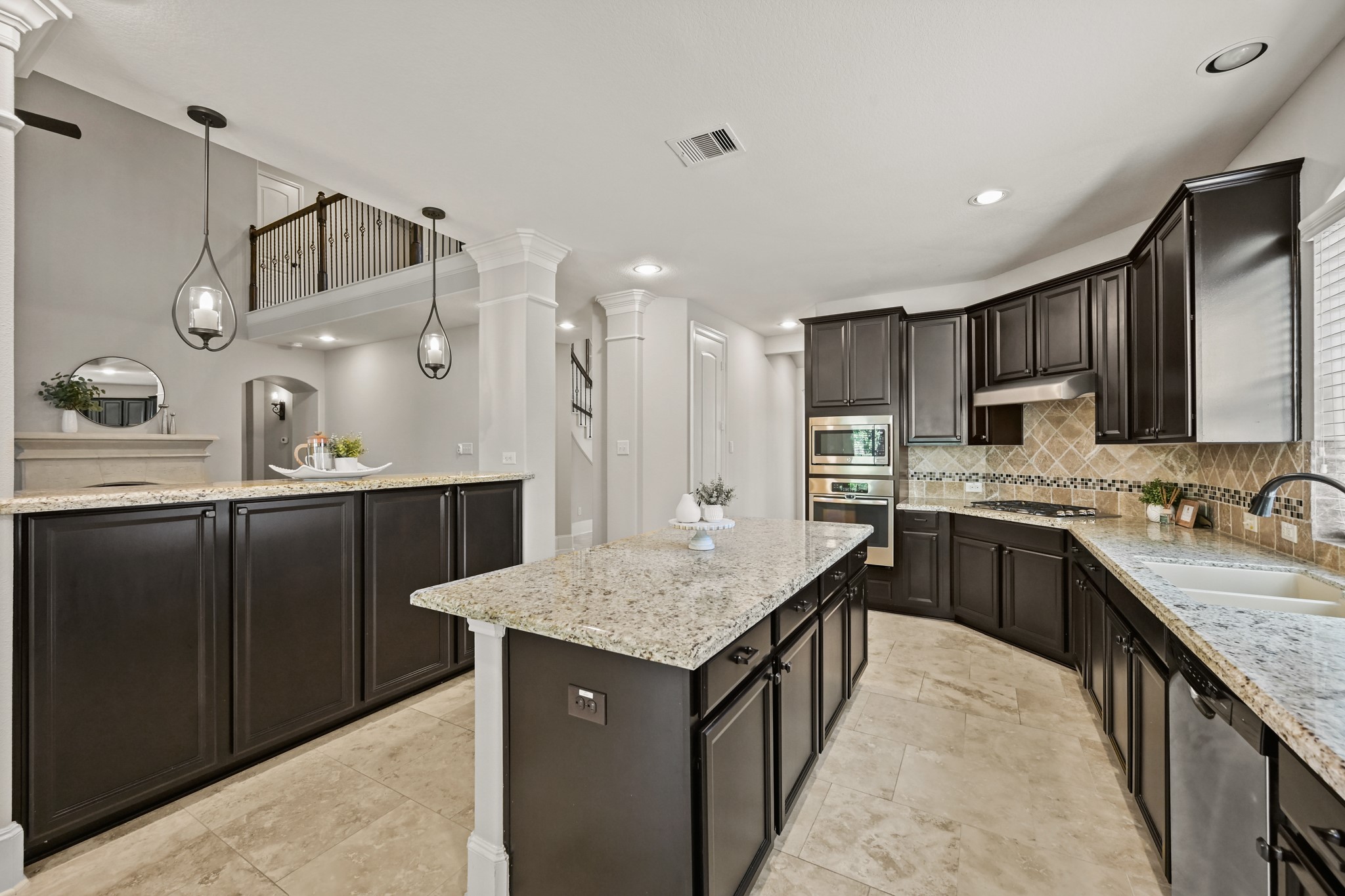 25202 Quiet Ledge Porter, TX 77365 - Photo 11 of 49 a kitchen with granite countertop a sink a counter space appliances and cabinets