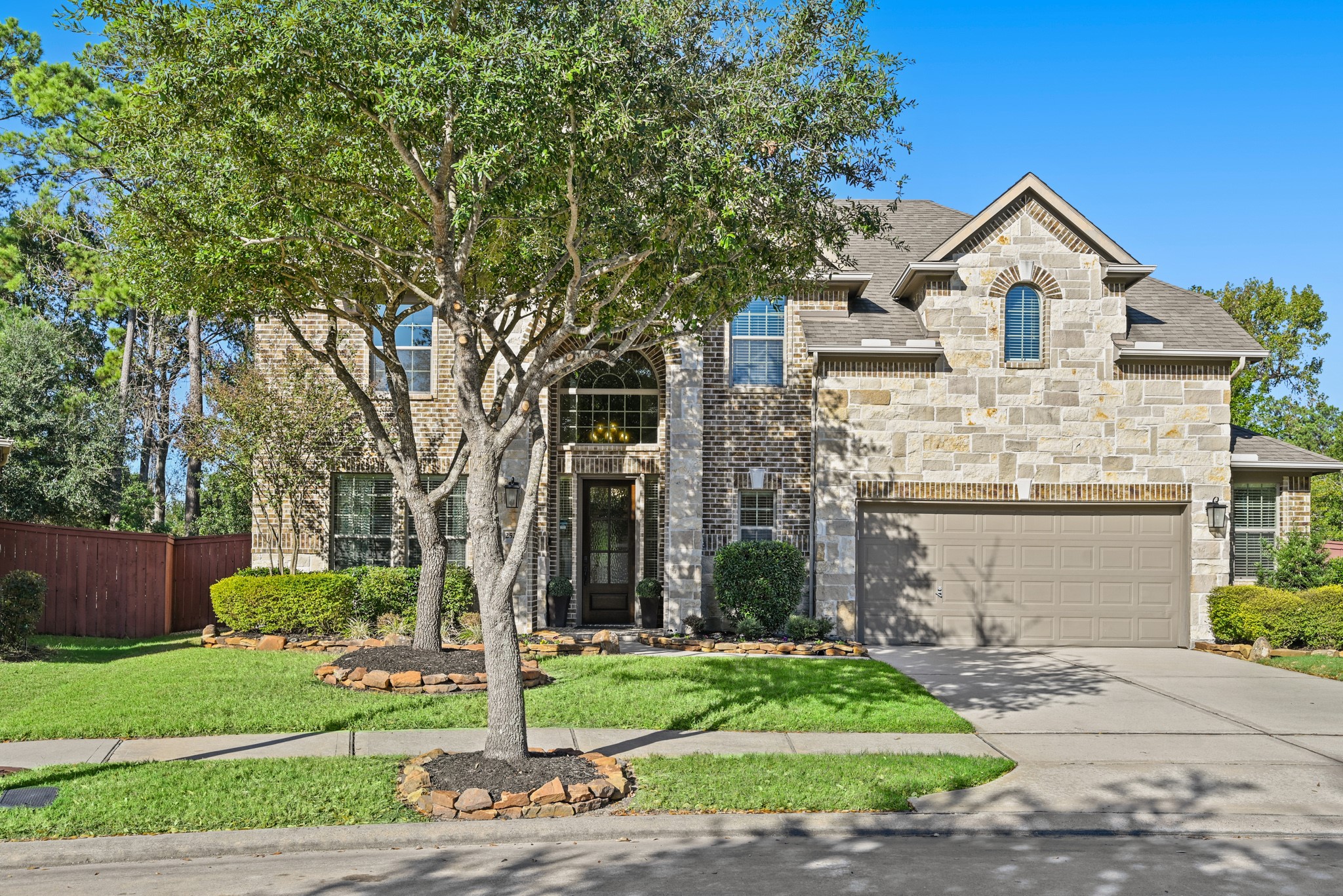 25202 Quiet Ledge Porter, TX 77365 - Photo 2 of 49 a front view of a house with a yard and garage