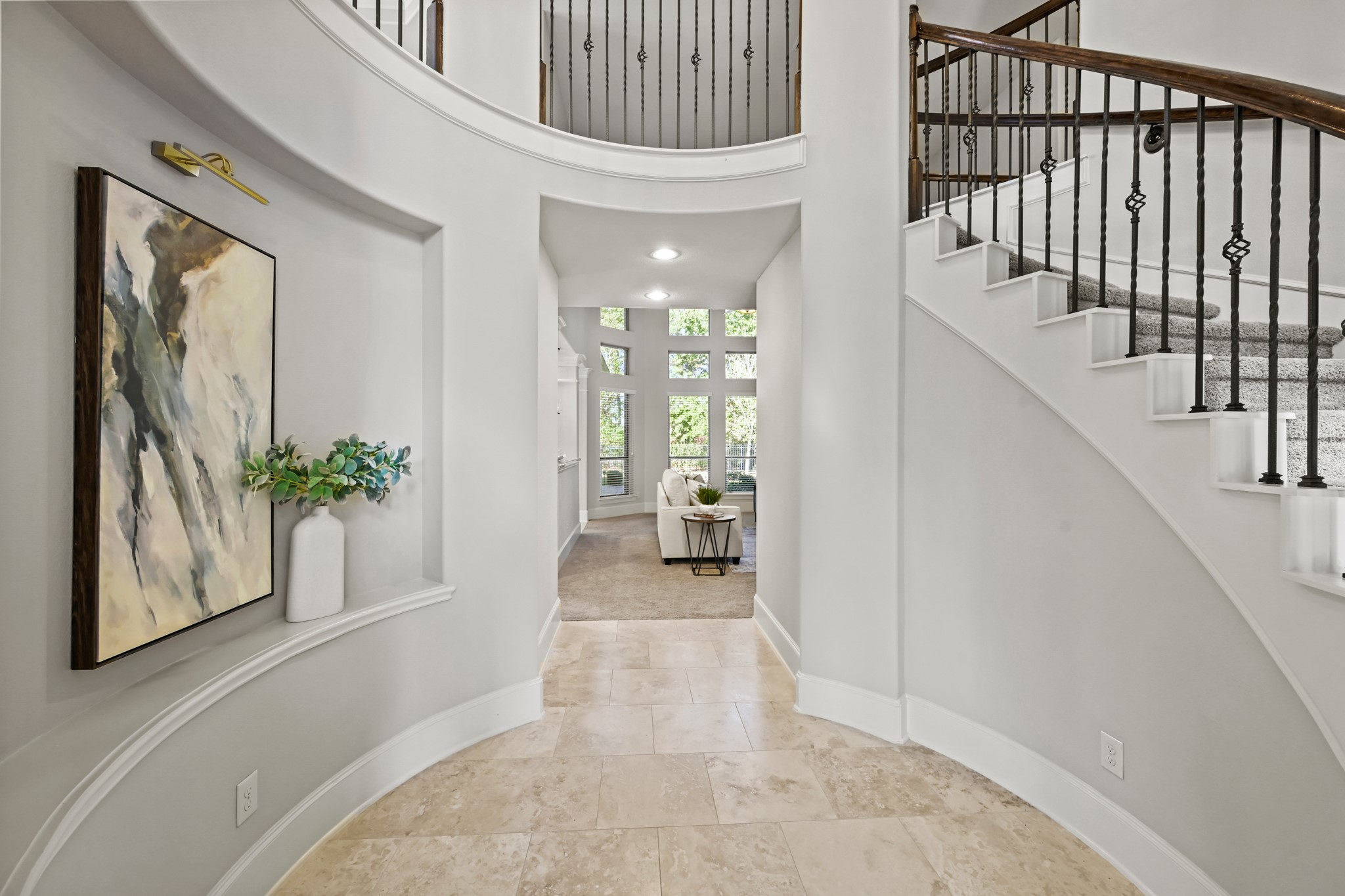 25202 Quiet Ledge Porter, TX 77365 - Photo 3 of 49 a view of a hallway to a livingroom with wooden floor and a staircase