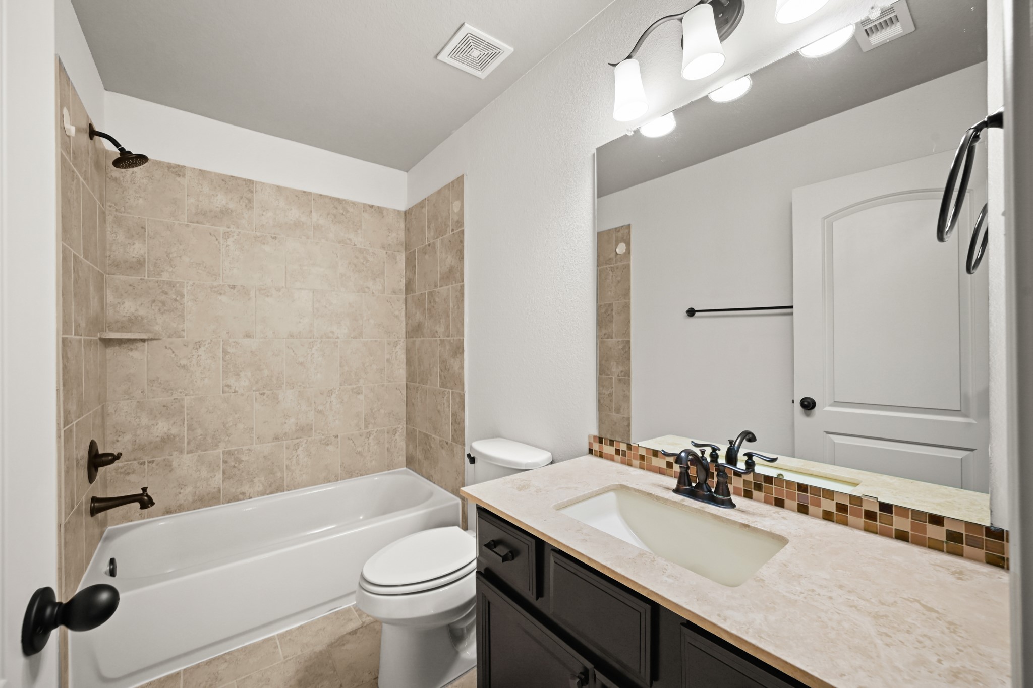 25202 Quiet Ledge Porter, TX 77365 - Photo 33 of 49 a bathroom with a granite countertop sink a toilet a mirror a bathtub and shower