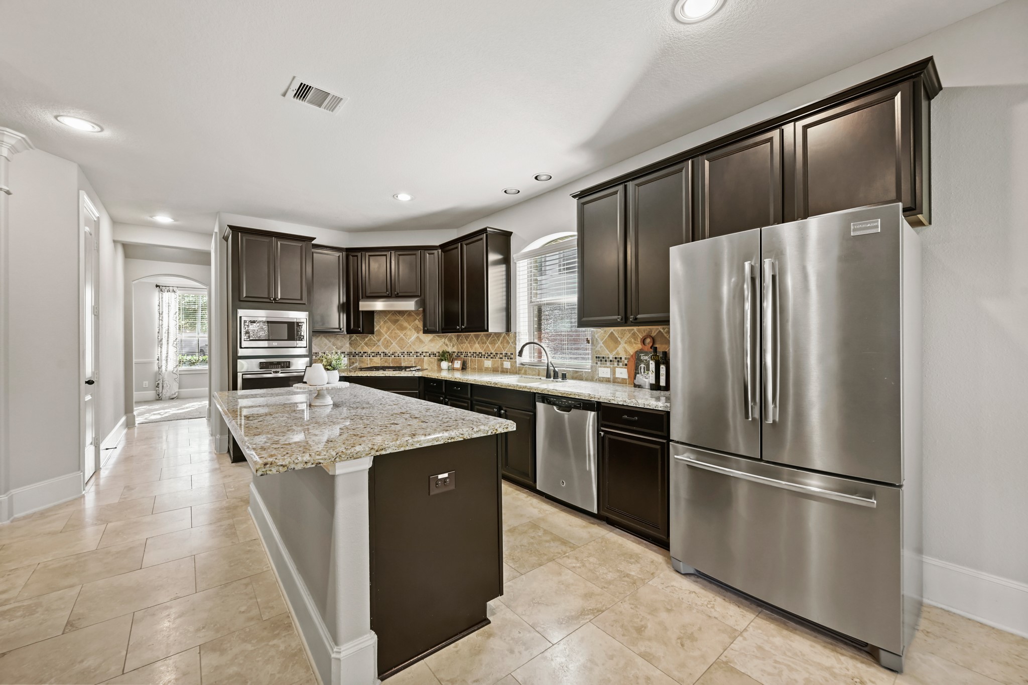 25202 Quiet Ledge Porter, TX 77365 - Photo 10 of 49 a kitchen with stainless steel appliances granite countertop a refrigerator stove microwave and cabinets