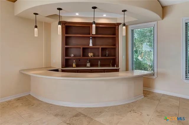 a large white kitchen with a large window
