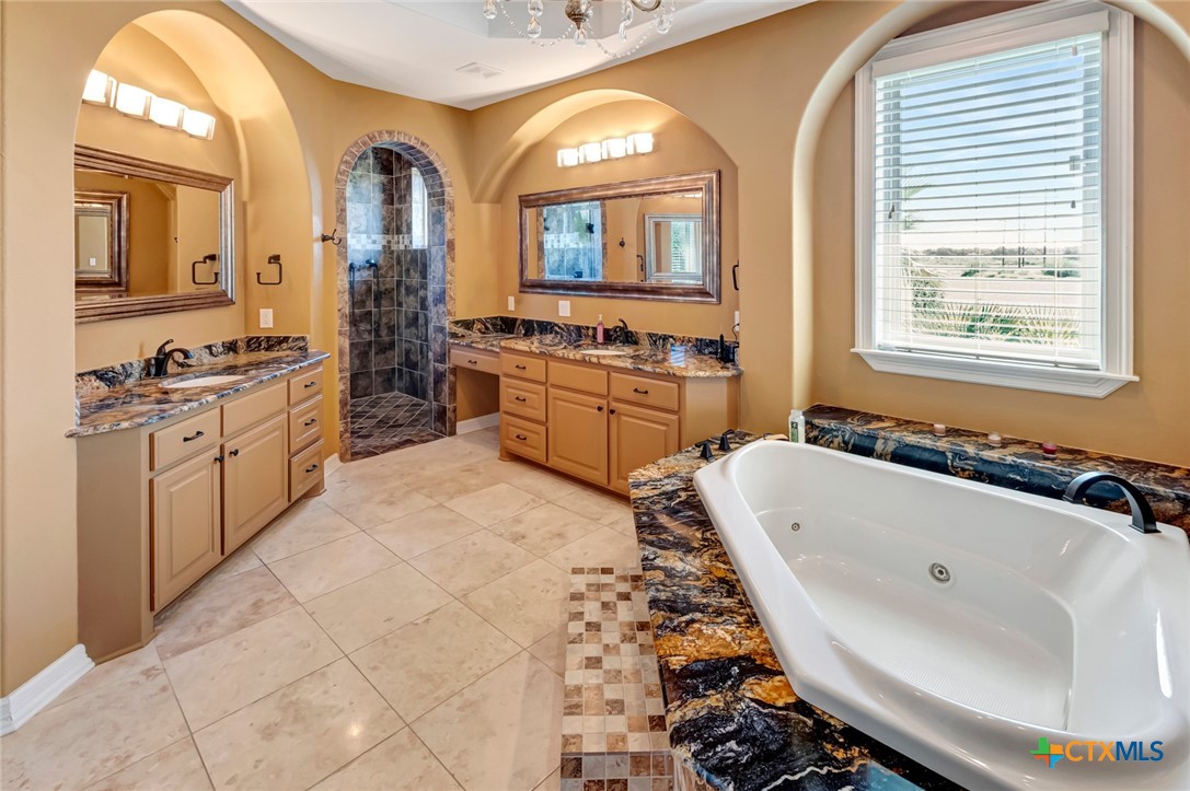 48 Post Oak Run Inez, TX 77968 - Photo 17 of 42 a bathroom with a tub sink and mirror