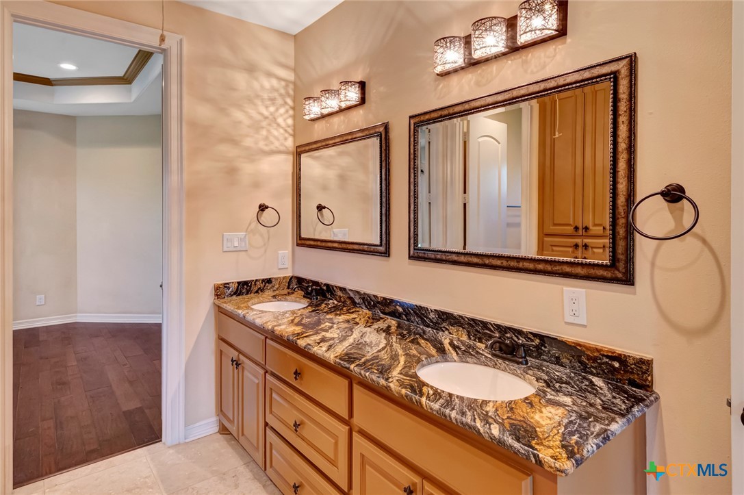 48 Post Oak Run Inez, TX 77968 - Photo 22 of 42 a bathroom with a granite countertop sink and a mirror