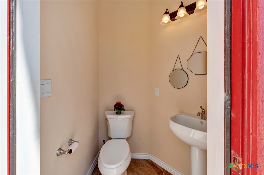 48 Post Oak Run Inez, TX 77968 - Photo 31 of 42 a white toilet sitting next to a bathroom sink