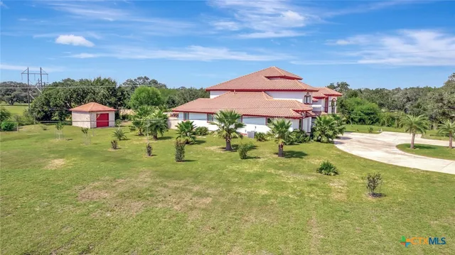a view of a swimming pool with a yard and plants