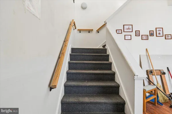 a view of staircase with lots of frames on wall