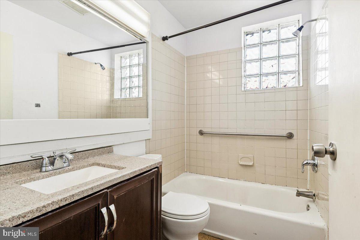5205-07 Webster Street Philadelphia, PA 19143 - Photo 17 of 37 a bathroom with a granite countertop sink toilet and shower