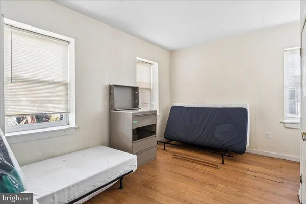 a living room with a bed furniture and a window
