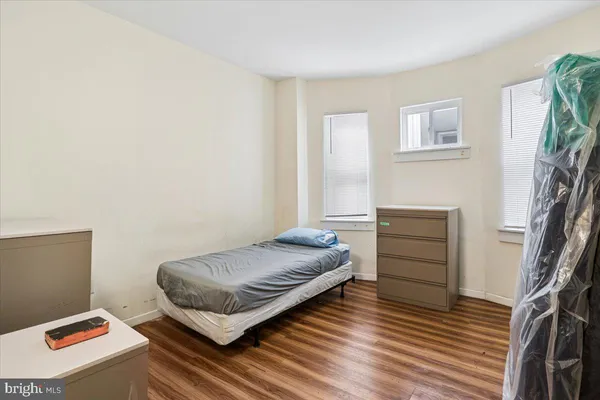a bedroom with a bed and a mirror