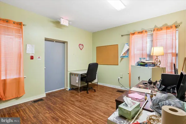 a view of a workspace with furniture and a window