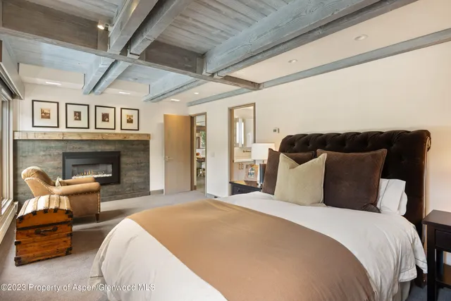 a bedroom with bed and wooden floor