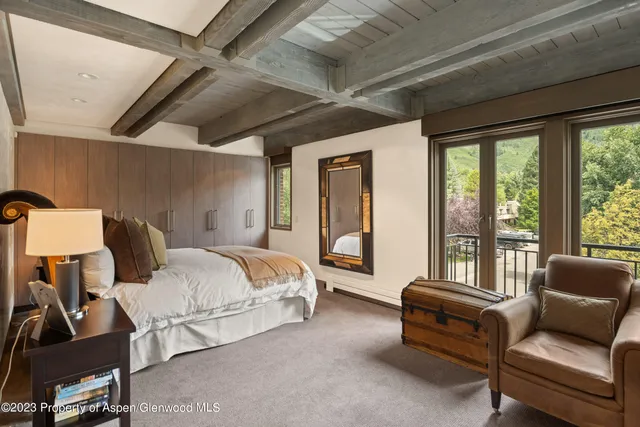 a bedroom with furniture and large windows