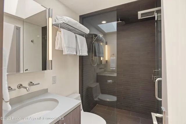 a bathroom with a sink toilet and shower