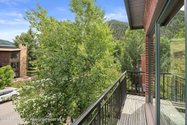 a balcony with trees in front of it