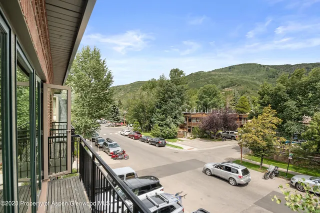 a terrace with a bench and trees