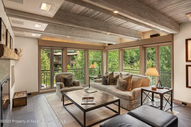 a living room with furniture and a floor to ceiling window