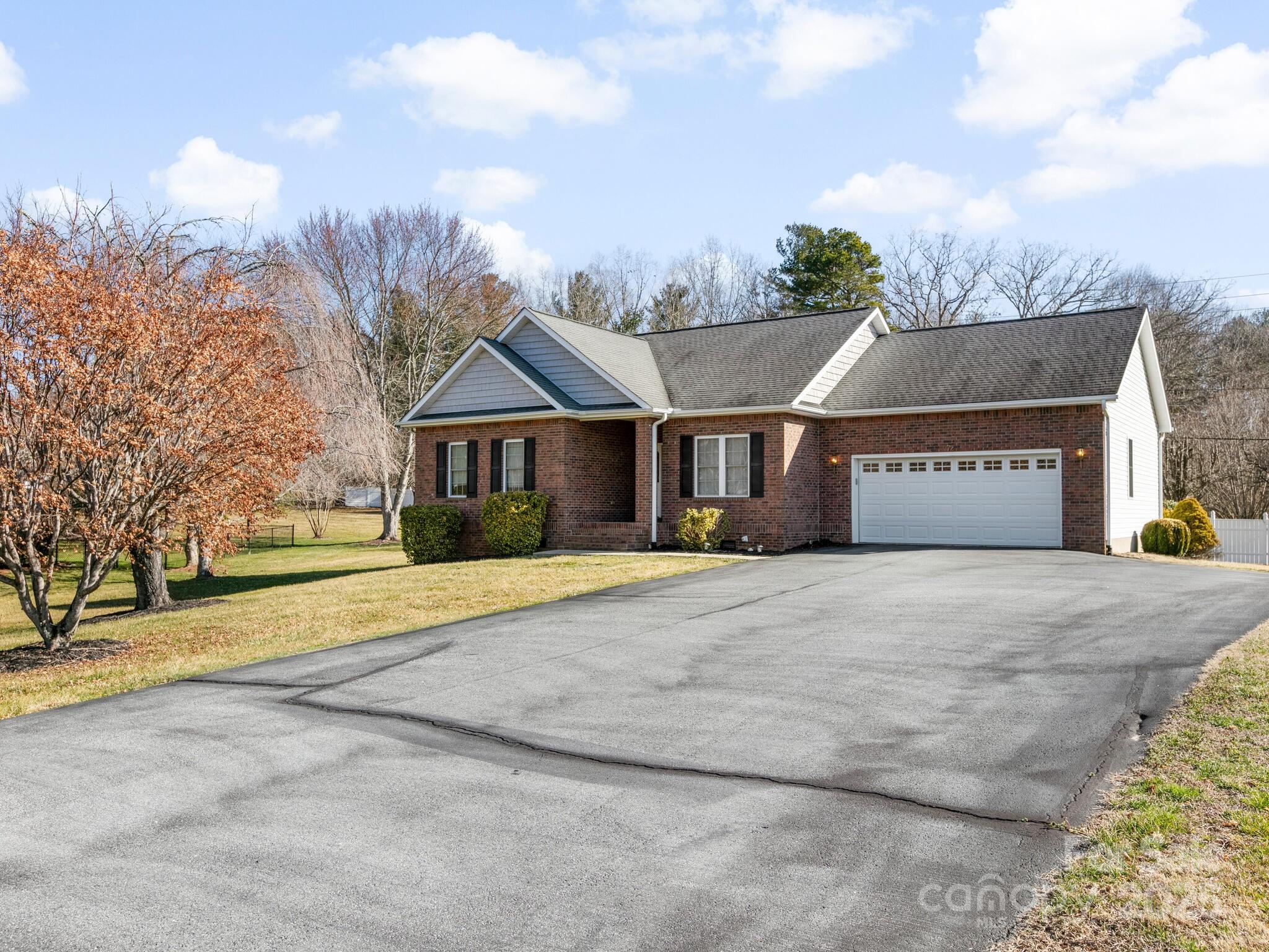 72 Classic Oaks Circle Hendersonville, NC 28792 - Photo 1 of 39 a front view of a house with a yard and garage