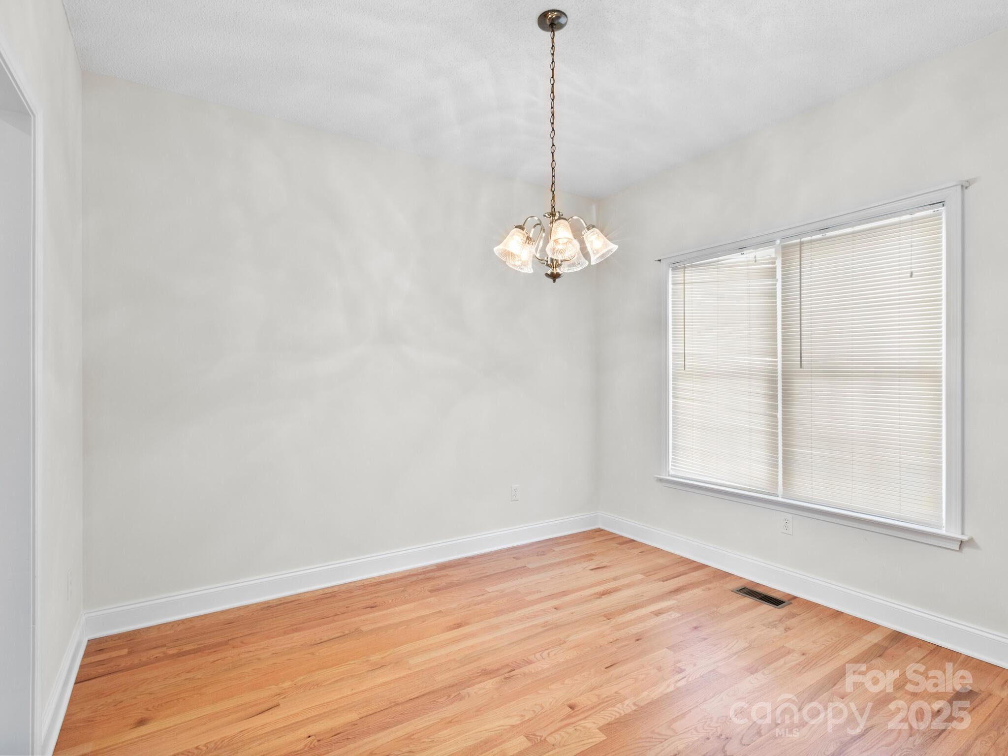 72 Classic Oaks Circle Hendersonville, NC 28792 - Photo 21 of 39 a view of an empty room with chandelier and a window