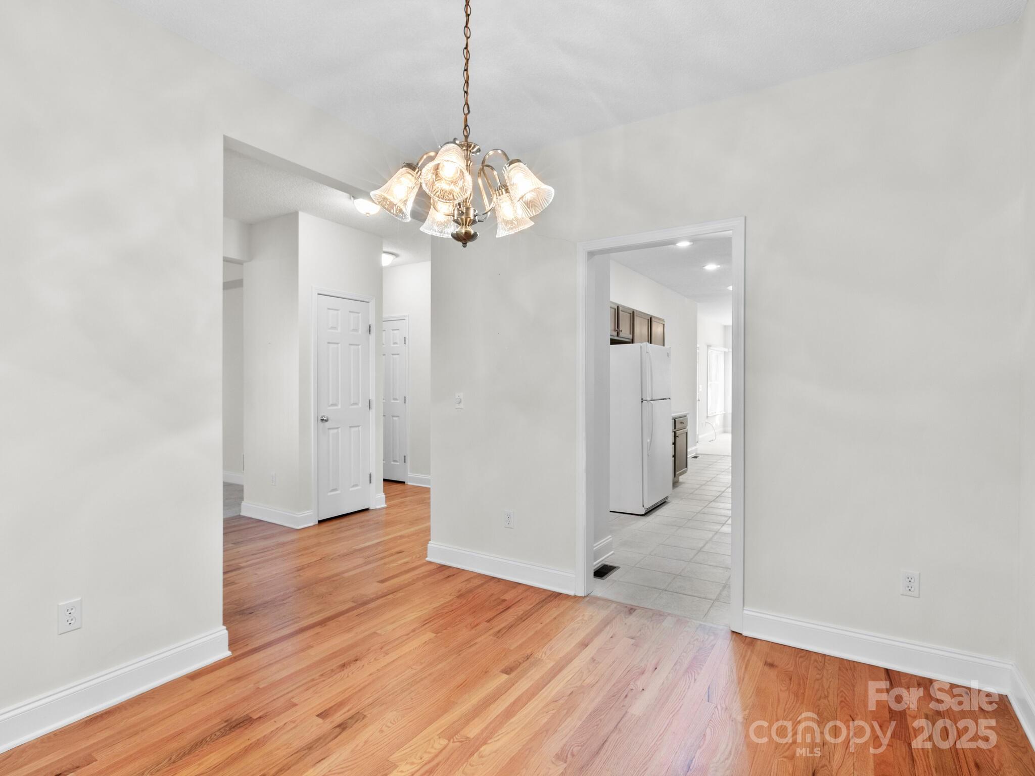 72 Classic Oaks Circle Hendersonville, NC 28792 - Photo 22 of 39 a view of a big room with wooden floor and chandelier