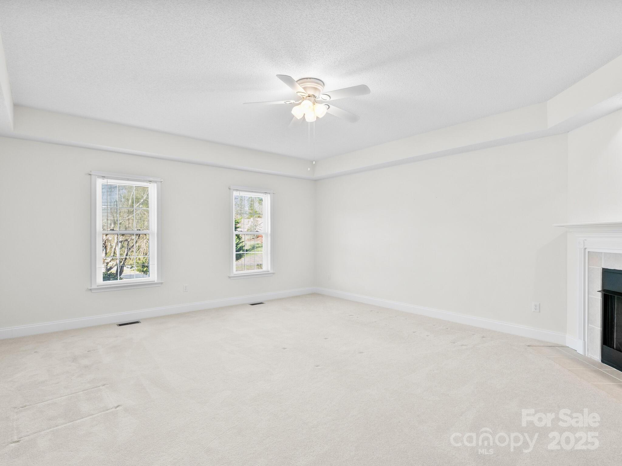 72 Classic Oaks Circle Hendersonville, NC 28792 - Photo 6 of 39 an empty room with windows and fan