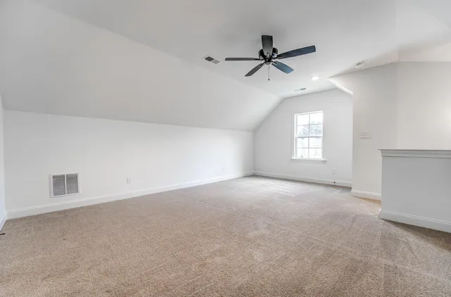 a view of a livingroom with a ceiling fan and window