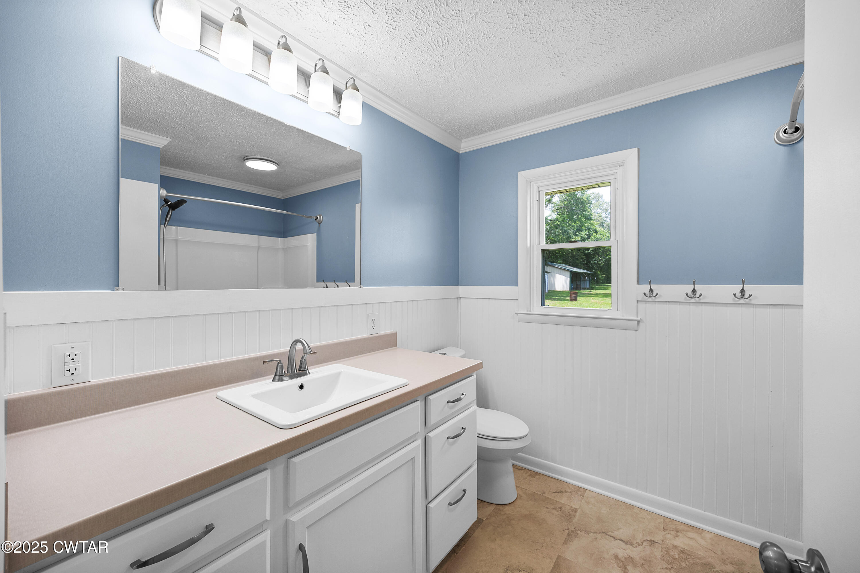 2901 Beech Bluff Road Jackson, TN 38301 - Photo 21 of 23 a bathroom with a sink a toilet and a mirror