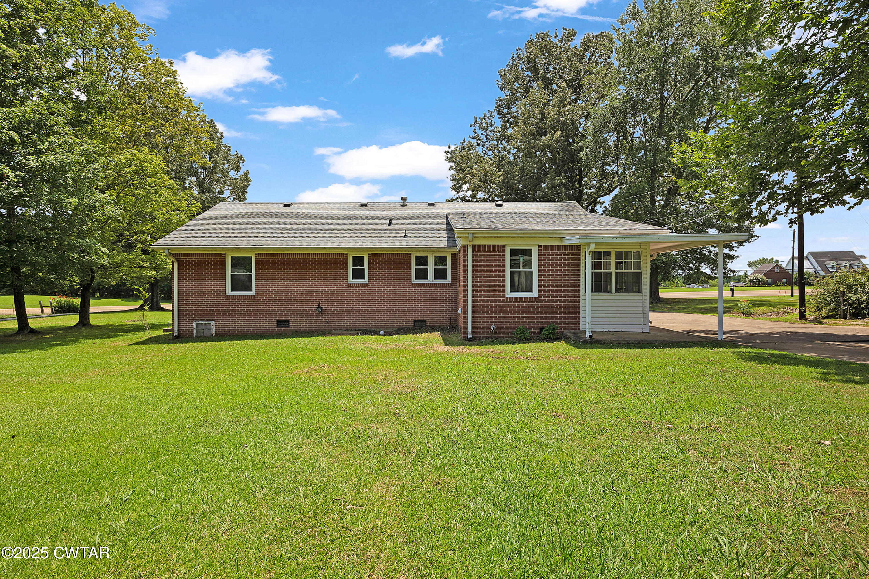 2901 Beech Bluff Road Jackson, TN 38301 - Photo 3 of 23 a view of a yard in front of a house with a garden