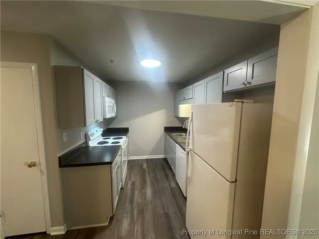a kitchen with sink a refrigerator and a stove