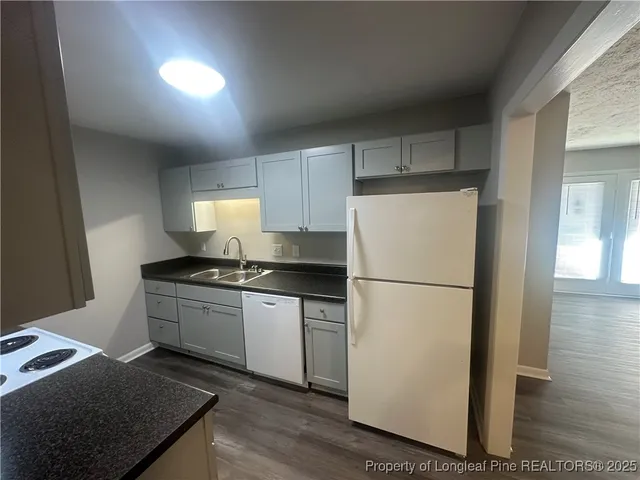 a white refrigerator freezer sitting inside of a kitchen