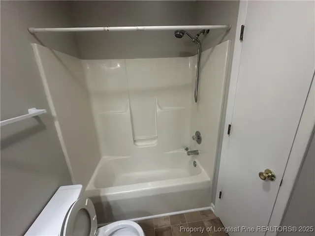 a bathroom with a shower and a bath tub